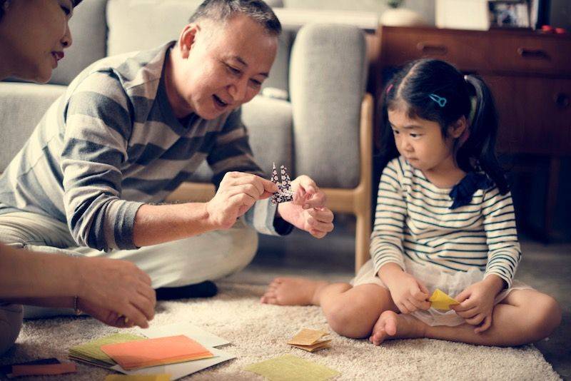 grandfather and granddaughter playing together