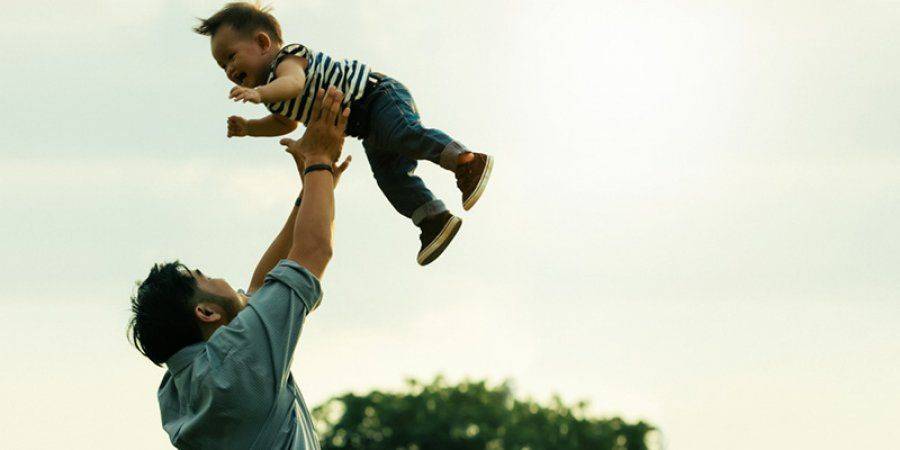 father lifting his son up in the air