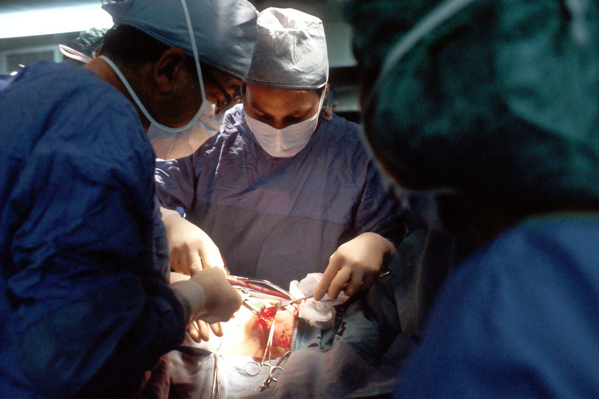 medical staff performing surgery on patient 
