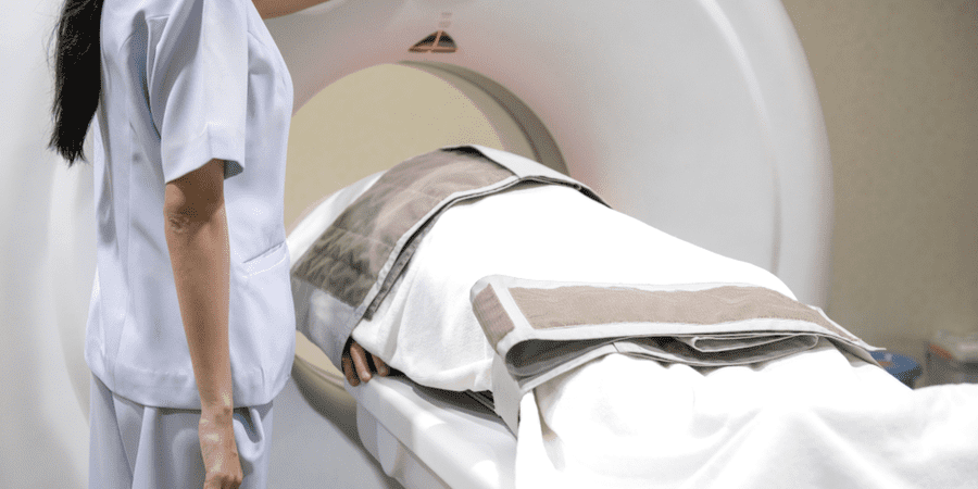 radiographer performing CT Scan on patient at hospital