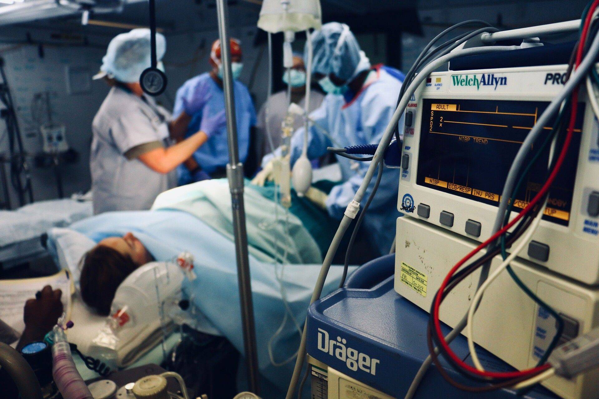 ICU patient receiving care from medical staff